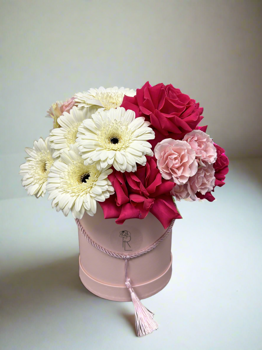 Pink fresh flower box with hot pink roses, light pink spray roses and white gerberas